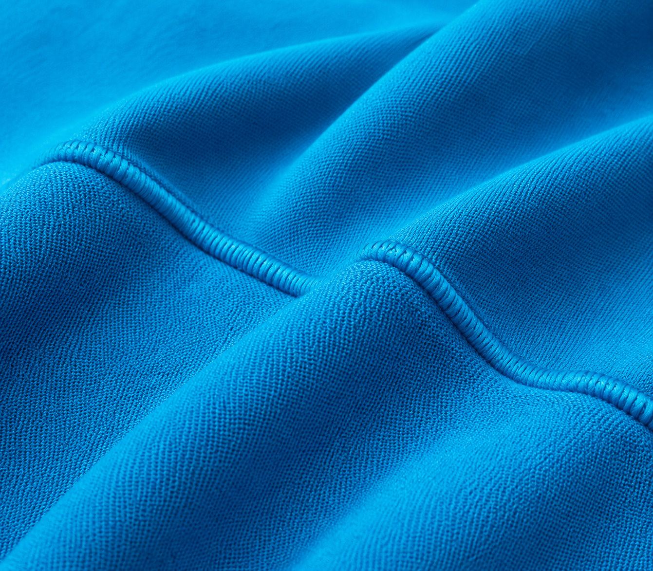Macro of 100% cotton fleece face knit — dense print surface with coverstitch detail